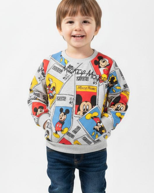 Child wearing a colorful sweater with cartoon characters on a white background, featuring the brand 'Lucky Tucky'.