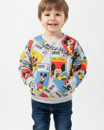 Child wearing a colorful sweater with cartoon characters on a white background, featuring the brand 'Lucky Tucky'.